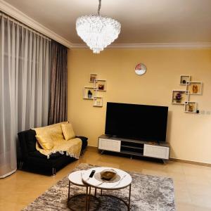 a living room with a tv and a couch at Best place to stay by the sea in Ajman 