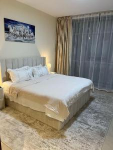 a bedroom with a large bed and a window at Best place to stay by the sea in Ajman  +28 photos