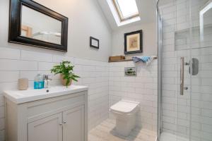 a bathroom with a toilet and a sink and a shower at Chantry Cottage in Chard +45 photos