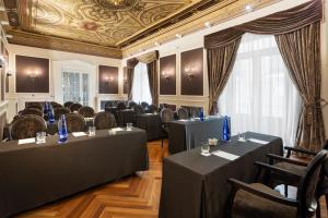 a room with tables and chairs and a ceiling at Catalonia Las Cortes in Madrid