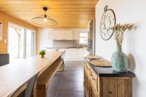 a kitchen with a large wooden counter and a clock on the wall at chalets les biches in Gérardmer
