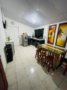 a kitchen with a table and chairs in a room at Surf Marola Sunzal in El Sunzal