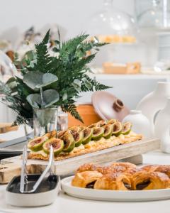 a table topped with plates of pastries and pies at Hospes Puerta de Alcalá, a Member of Design Hotels in Madrid