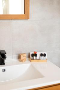 a bathroom sink with three cups on a counter at Sweet - Superbe appartement avec parking privé - Paris-Disney & CDG à 25 minutes in Pomponne +32 photos