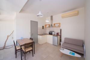 a kitchen and a living room with a table and a couch at Casa Dina 2 in Lefkada