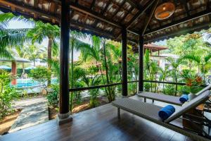 a room with a view of the pool at a resort at Herbal Resort & Spa in Phu Quoc
