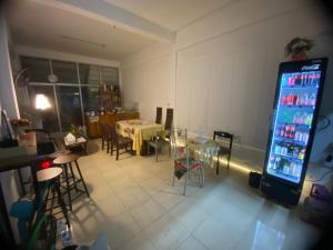 a room with a vending machine and a table and chairs at Sleep Break Hostel Sathon in Bangkok