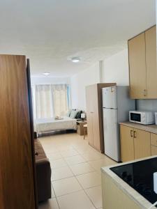 a kitchen with a refrigerator and a couch in a room at Marielenas in Larnaca +8 photos