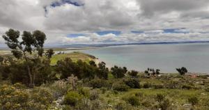 a view of the ocean from the top of a hill at Inti Raymi Lodge in Escallani