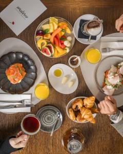 a table with a bunch of plates of food at Hospes Puerta de Alcalá, a Member of Design Hotels in Madrid