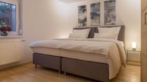a bedroom with a large bed with white pillows at Villa - Ettenheim in Ettenheim