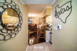 a kitchen and dining room with a mirror on the wall at Sunset & Lake View on Island Retreat in Lago Vista