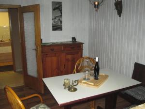 a dining room table with a bottle of wine on it at Eulennest in Carlsberg
