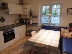 a small kitchen with a table and a counter top at Haus Romy in Hagermarsch