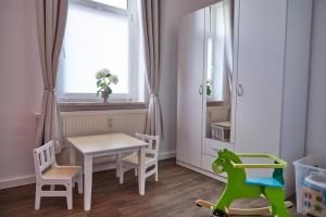 a small childs room with a table and chairs at City-Apartment 1 in Bernburg