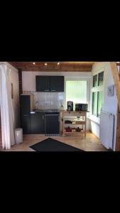 a kitchen with a white refrigerator and a stove at Waldoase 2 in Rheinsberg