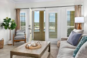 a living room with a couch and a table at Island Summer Sunrises Spa Eats Last Minute Deals! in Lago Vista