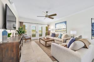 a living room with a couch and a ceiling fan at Island Summer Sunrises Spa Eats Last Minute Deals! in Lago Vista