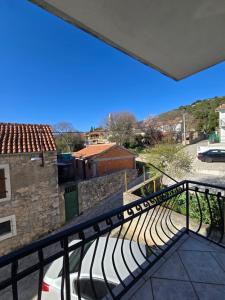 a view from the balcony of a building with a bench at Apartman Lucija in Jezera