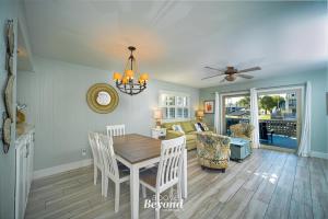 a dining room and living room with a table and chairs at The Cobalt Crab Oasis in Rockport
