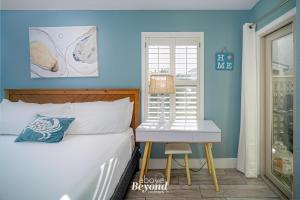 a bedroom with a bed and a chair next to a window at The Cobalt Crab Oasis in Rockport +52 photos