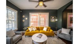 a living room with a yellow couch and a table at The Royal Treatment Downtown, Great for Travels in San Antonio