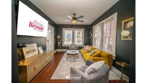 a living room with a couch and a tv at The Royal Treatment Downtown, Great for Travels in San Antonio +35 photos