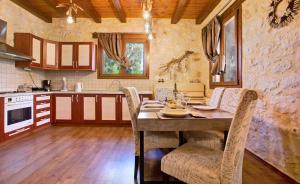 a kitchen with a table and chairs in a room at Villa Cana - Rustic Villa in Nature with Terrace in Lithakia +21 photos