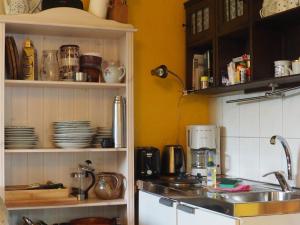 a kitchen with a sink and a counter with dishes at kleine Herta in Prerow