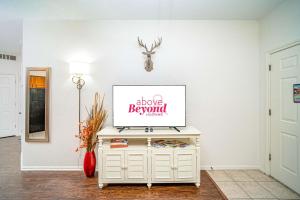 a living room with a tv on a white wall at Cozy Enclave Bursting with Amenities in Lago Vista
