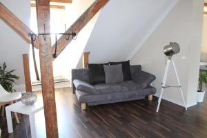 a living room with a couch and a tripod at Ferienwohnung "Turmblick" in Tellingstedt