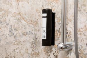 a black bottle is hanging on a door at Casa Morellato in Riva del Garda +152 photos