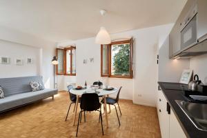 a kitchen and living room with a table and chairs at Casa Morellato in Riva del Garda