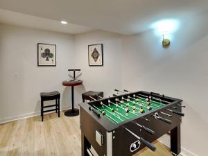 a large game room with a foos ball at Dacha Verde in Swanton