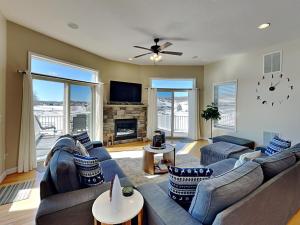 a living room with a blue couch and a tv at Dacha Verde in Swanton +56 photos
