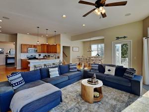 a living room with a blue couch and a kitchen at Dacha Verde in Swanton