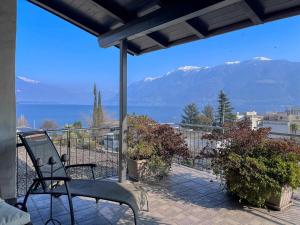 a balcony with a view of the ocean and mountains at Lakeview Hideaway - Brissago in Brissago