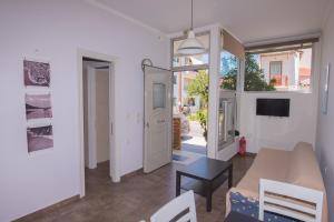 a living room with a couch and a table at Casa Dina 2 in Lefkada