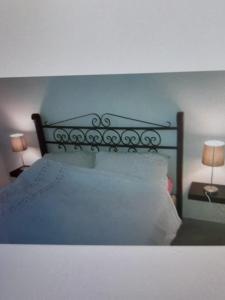 a bed with a black head board and two lamps at Beautiful 1-Bed House in Boghaz +22 photos