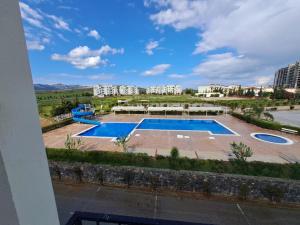 a view of a swimming pool with buildings in the background at Beautiful 1-Bed House in Boghaz