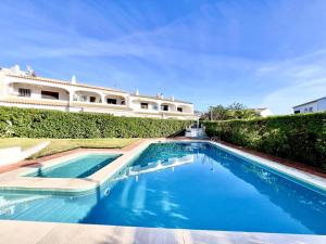 a swimming pool in front of a building at Vilamoura Classic 2 with Pool by Homing in Quarteira