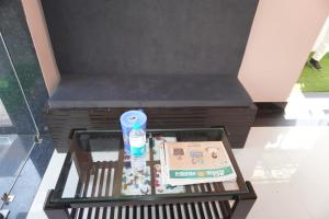 a glass table with a box and a toothbrush at Hotel Hanumat Palace-300 meter Jaipur junction & 1km Sindhi camp bus stand in Jaipur
