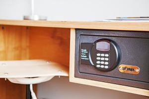 a microwave oven in a cabinet with a drawer at Ramada by Wyndham Belfast in Belfast