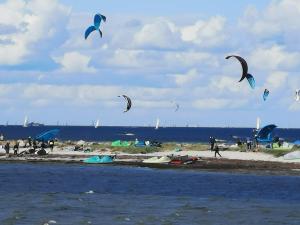 a group of people on a beach flying kites at Tornado in Laboe +13 photos
