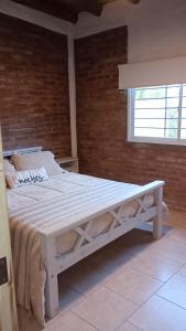 a white bed in a room with a window at Cortaderas de La Villa-San Rafael in San Rafael +37 photos