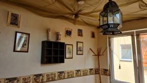 a room with a chandelier and pictures on the wall at Pension Kapellenstraße - Ferienwohnung mit individueller Ausstattung - jedes Zimmer ist anders Komplette Küche in Erfurt