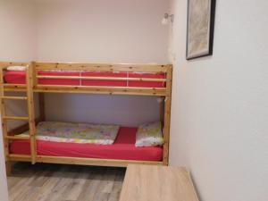 a room with two bunk beds and a table at Ferienhof Westermann Waldblick in Lähden