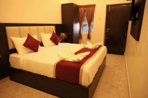 Postel nebo postele na pokoji v ubytování Hotel Sri Kanthan Residency