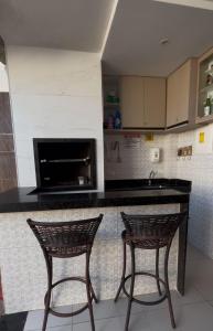 two chairs sitting at a counter in a kitchen at Casa Gravata in Gravatá