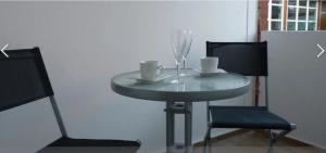a table with two chairs and a table with two cups at Butjadinger Friesenstube in Butjadingen